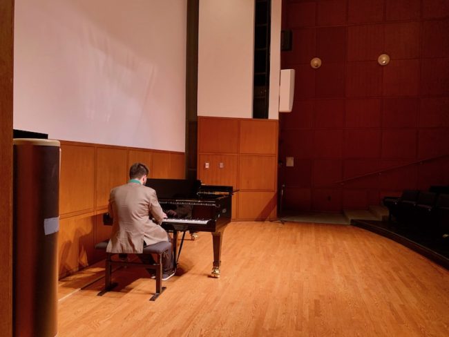 A performer at 24HC plays piano after the concert Photo credit: Audrey McClure
