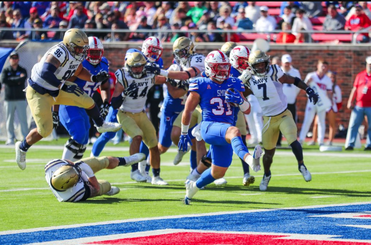 Tyler Lavine carries the ball across to the endzone at the home game against Navy in November 2023.