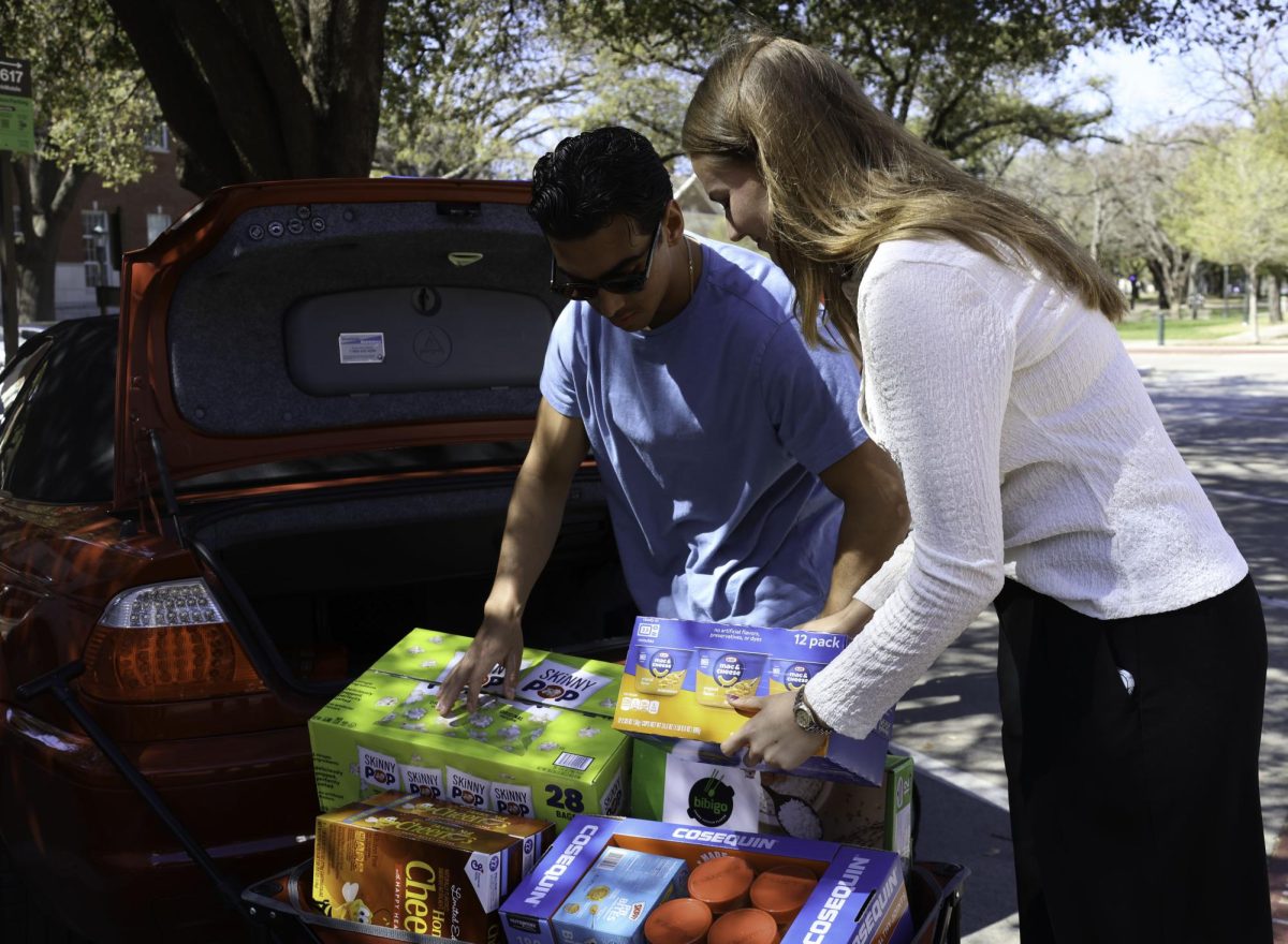 MSBA volunteers Bree Slay and Chandler Kaudy unload food from their car to donate to The Shop