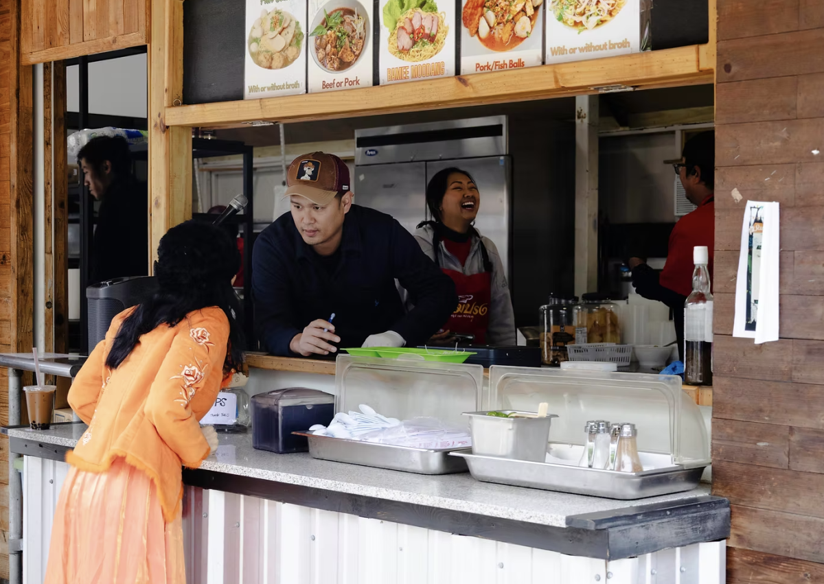 Vendor taking a customer's order at the Thai Temple on Sunday, April 6, 2025.